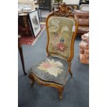 A Victorian carved walnut nursing chair with floral embroidered upholstery, height 112cm