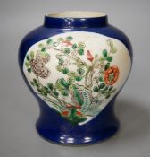 A Chinese powder blue vase, late 19th century, with panelled floral decoration (a.f.). 12cm high