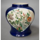 A Chinese powder blue vase, late 19th century, with panelled floral decoration (a.f.). 12cm high