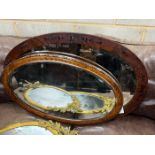 Two early 20th century oval wall mirrors, larger width 86cm
