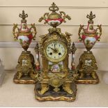 A 19th century Louis XV style gilt metal and porcelain mounted three piece clock garniture, clock