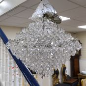 A ten tier, eighteen light, graduated chrome chandelier, with diamond shaped clear perspex drops