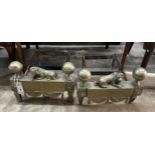 A pair of 19th century wrought iron and brass recumbent lion fire dogs, width 34cm, depth 36cm