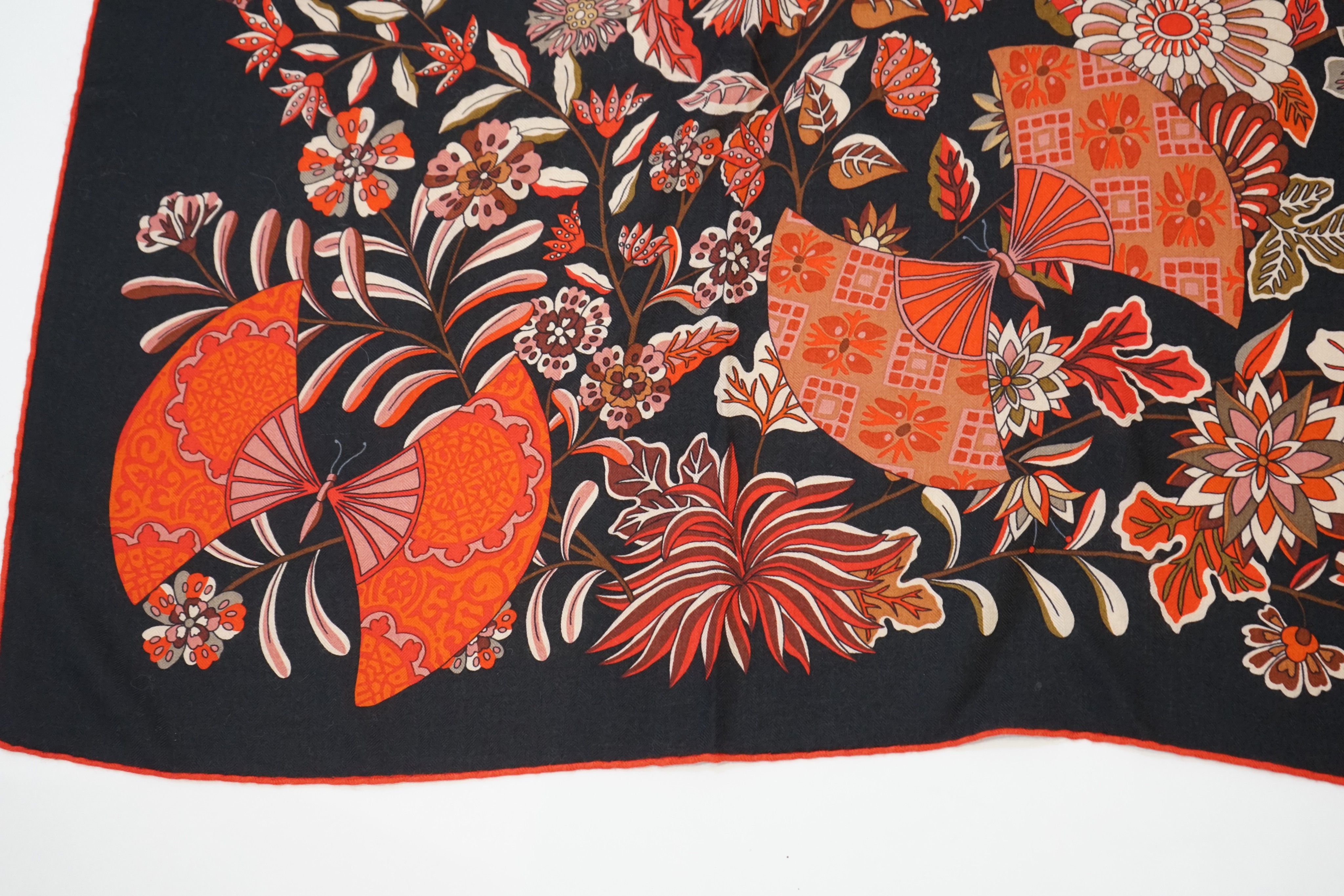 An Hermes wool scarf, with fan and flower motifs on a black ground, in Hermes cloth bag 132 cm. - Image 5 of 6