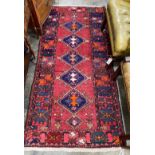 A Caucasian style red ground rug, 200 x 96cm
