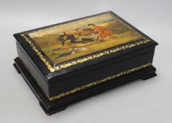 A Russian painted and ebonised box, 23cms wide