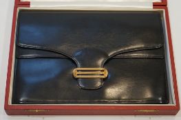 A vintage Cartier, London black leather handbag, fitted with original mirror and purse, in