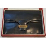 A vintage Cartier, London black leather handbag, fitted with original mirror and purse, in