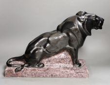 A French Art Deco ceramic model lion, signed Francisque, 31cms high