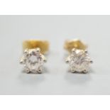 A pair of yellow metal and solitaire diamond set ear studs, gross weight 1.2 grams, each stone