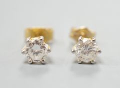 A pair of yellow metal and solitaire diamond set ear studs, gross weight 1.2 grams, each stone