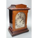 An early 20th century German walnut and marquetry chiming mantel clock, 42cms high