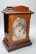An early 20th century German walnut and marquetry chiming mantel clock, 42cms high