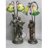 Two bronzed metal figural table lamps, with Art Nouveau style glass shades, 66cm total