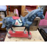 A 1930's German moulded and painted composition pull-along horse, height 96cm