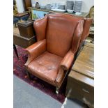 A pair of George III style studded red leather wingback armchairs, width 79cm