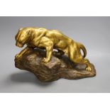 A gilt terracotta model of a panther on a rock, 21cms high