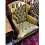 A George III style button green leather armchair, width 65cm, depth 68cm, height 98cm