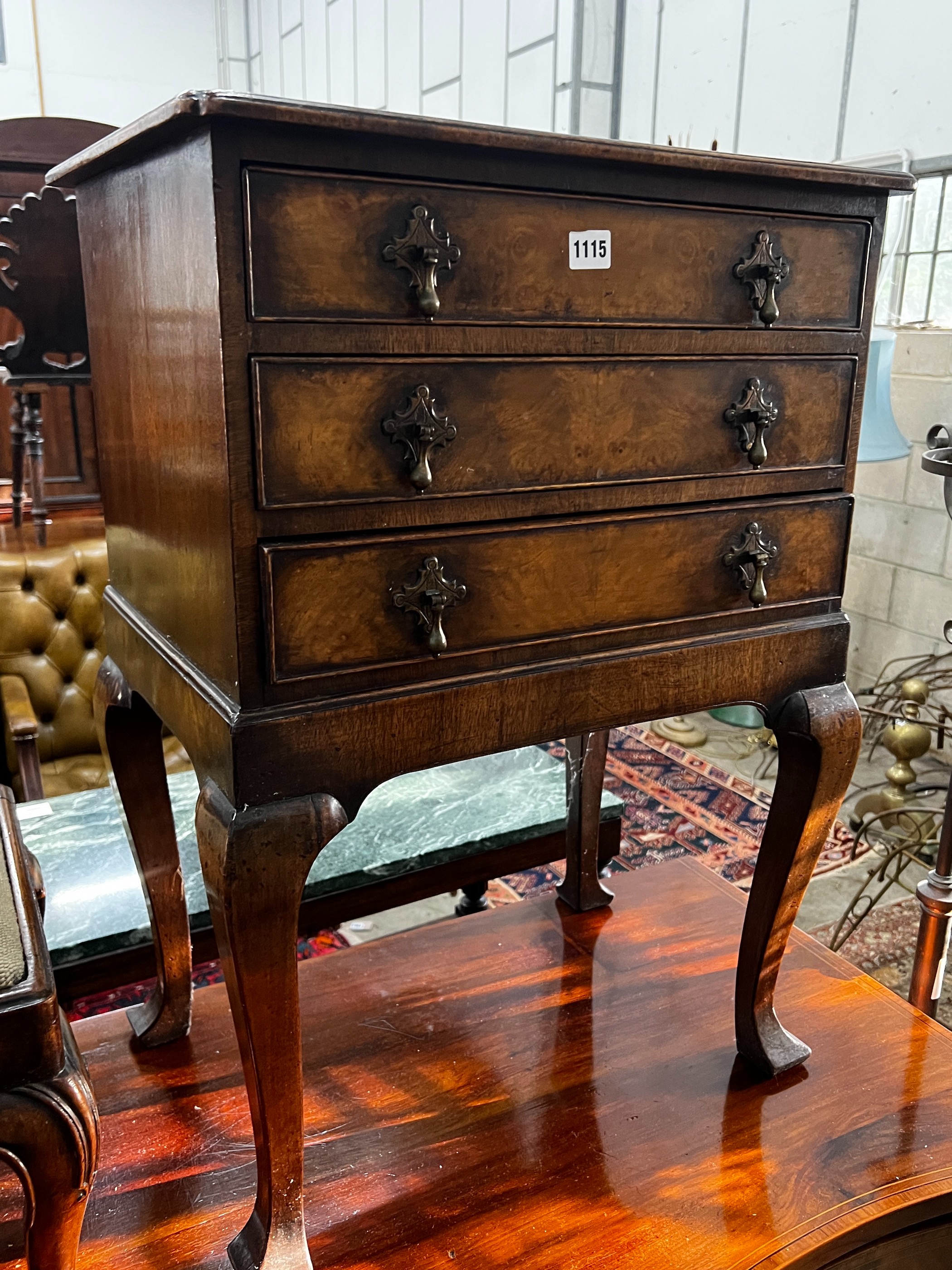 A George III style walnut bedside chest, fitted three long drawers, width 53cm, depth 39cm, height