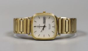 A gentleman's gold plated Omega Seamaster day/date quartz wrist watch, on associated flexible