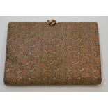 A vintage Christian Dior brocade clutch bag, with faux ruby set clasp and original mirror