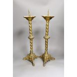 A pair of gilt brass pricket sticks, 51cms high