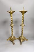A pair of gilt brass pricket sticks, 51cms high