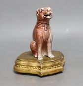 A Chinese porcelain model of a seated dog on gilt wood stand, 19cm tall