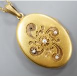 A yellow metal and seed pearl set oval locket stamped 56? (one flower motif with pearl missing),