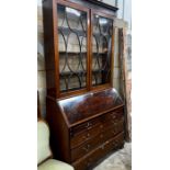 A George III inlaid mahogany bureau, with later top section, width 116cm, depth 51cm, height 232cm