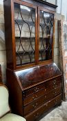 A George III inlaid mahogany bureau, with later top section, width 116cm, depth 51cm, height 232cm
