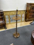 An early 20th century twist column oak and rosewood floor candlestand, height 99cm