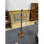 An early 20th century twist column oak and rosewood floor candlestand, height 99cm