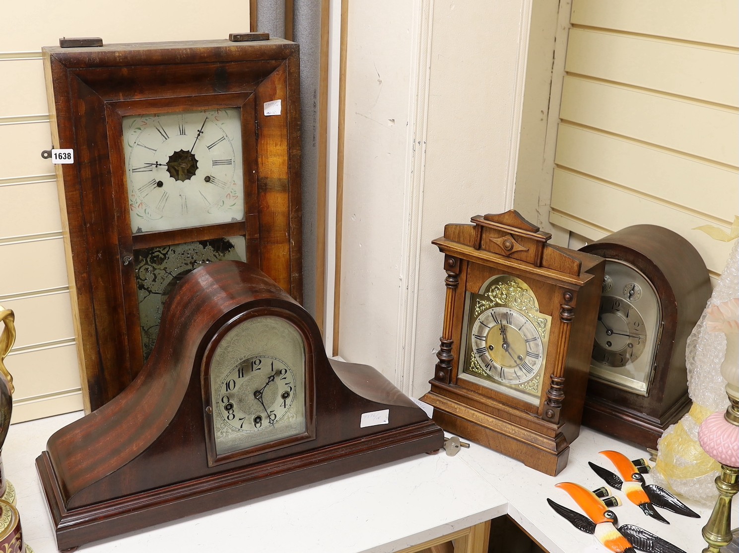 Two domed mantel clocks, a Connecticut shelf clock and a Black Forest mantel clock