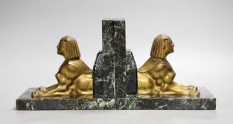 A pair of bronze and marble 'sphynx' bookends, 17cms wide x 15cms high