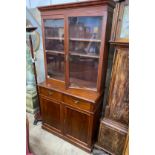 A late Victorian mahogany bookcase cupboard, width 108cm, depth 52cm, height 215cm