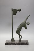 An Art Deco bronze on marble base, of a basket ball player, 32cms high