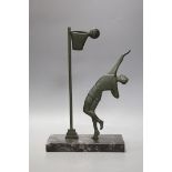 An Art Deco bronze on marble base, of a basket ball player, 32cms high