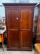 An early 20th century George III style panelled mahogany wardrobe, length 132cm, depth 42cm,