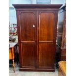 An early 20th century George III style panelled mahogany wardrobe, length 132cm, depth 42cm,