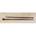 Two carved wood walking sticks, longest 91cms