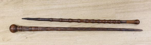 Two carved wood walking sticks, longest 91cms