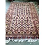 A Hamadan carpet with central field of foliate motifs on a sand coloured ground, 300 x 195cm
