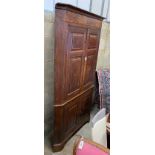 A George III mahogany banded oak standing corner cabinet, width 118cm, depth 64cm, height 224cm