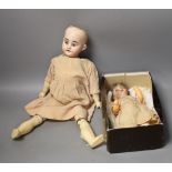 An Armand Marseille bisque headed doll, another German bisque headed doll and a miniature bisque