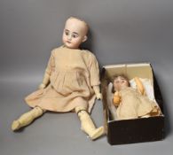 An Armand Marseille bisque headed doll, another German bisque headed doll and a miniature bisque