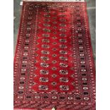 A Bokhara red ground rug, 150 x 95cm