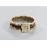 A 19th century yellow metal and plaited hair set band, the ring head with engraved monogram, size