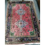 A Caucasian style red ground rug, 150 x 100cm