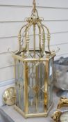 A hexagonal brass and bevelled glass hall lantern, 70 cms high,